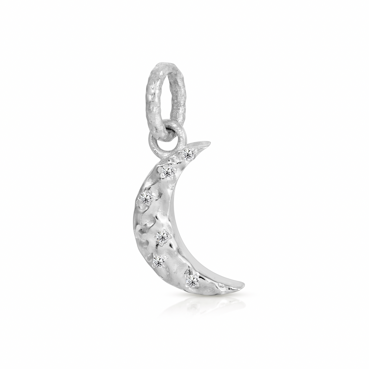 A silver crescent moon charm embellished with small clear stones, shown on a clean white background with a soft reflection.