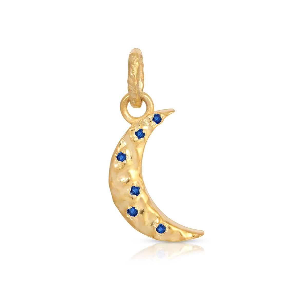 A yellow gold crescent moon charm pendant decorated with small dark blue gemstones, shown on a clean white background.
