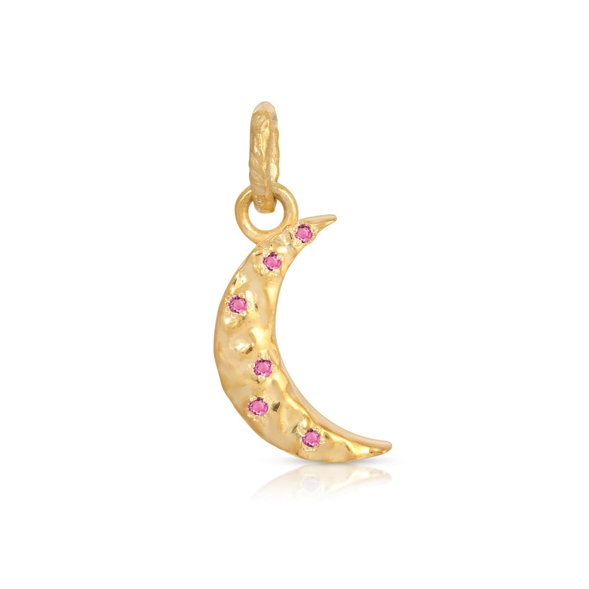 A gold crescent moon pendant charm embellished with small pink gemstones, shown on a clean white background with a soft reflection below.