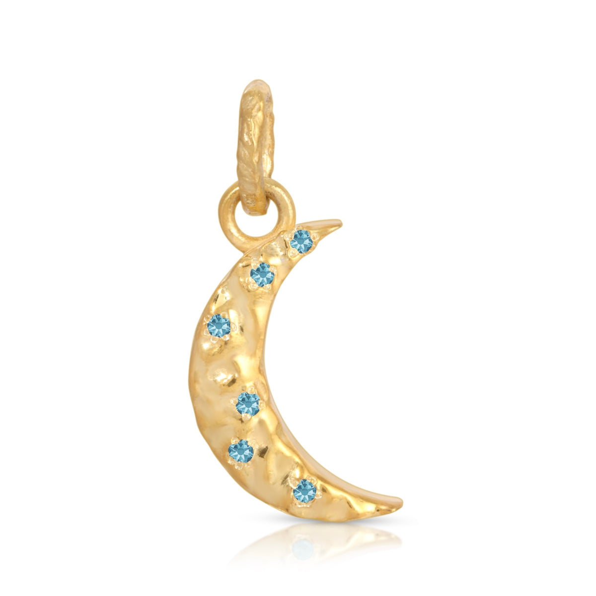 A gold crescent moon charm decorated with six small round-cut light blue gemstones, shown on a clean white background with a subtle reflection