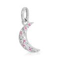 A silver crescent moon charm pendant decorated with small pink gemstones, shown on a clean white background.