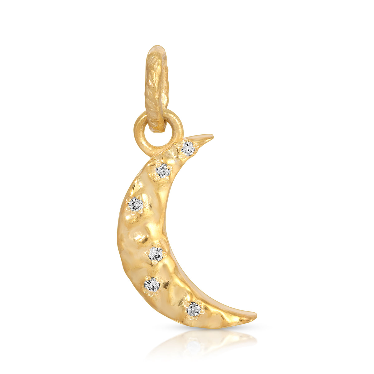 A gold crescent moon charm pendant with a textured finish and six small clear gemstones set along the curve, shown on a white background with a soft reflection.