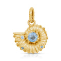 A gold ammonite pendant charm featuring a central round light blue gemstone and three smaller light blue accent stones, shown on a clean white background.