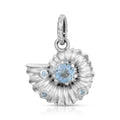 A sterling silver ammonite shell pendant charm featuring a central light blue round gemstone and three smaller light blue accent gemstones, shown on a clean white background.